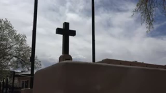 TAOS NEW MEXICO-2015: Dark Gray Cross Against White Clouds On A Clear Day
