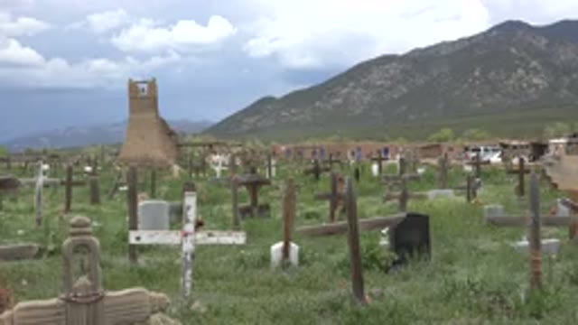 TAOS NEW MEXICO-2015: Graveyard Of Wooden Crosses In A Grassy Field Below A