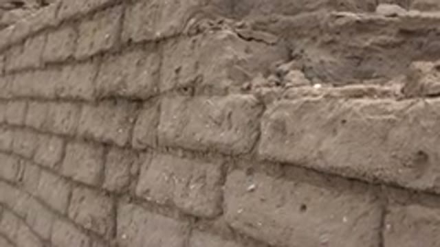 TAOS NEW MEXICO-2015: Crumbling Brown Brick Wall On A Clear Day