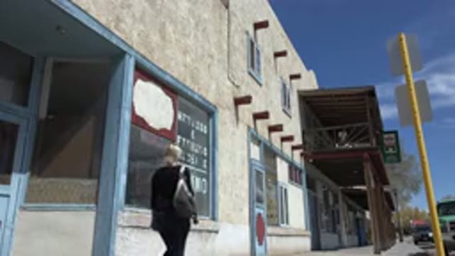 TAOS NEW MEXICO-2015: A Shot Of The Back Of A Woman Walking Down The Sidewalk