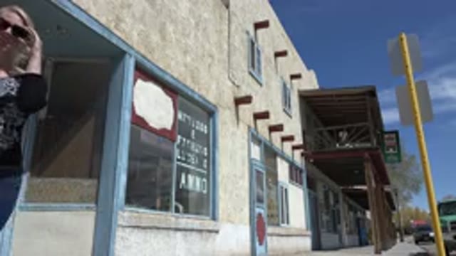 TAOS NEW MEXICO-2015: Woman Walking Down The City Street On The Sidewalk During