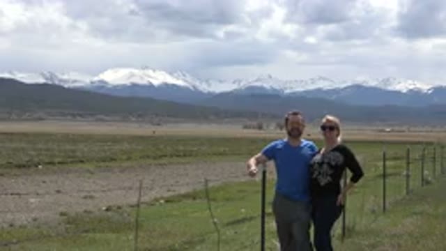 TAOS NEW MEXICO-2015: Happy Couple Of Tourists Posing And Raising Legs In A