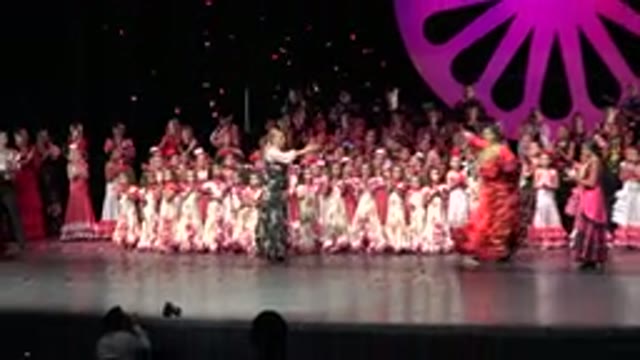 CABO SAN LUCAS MEXICO-2019: A Woman Wearing Red And Gold Custom Taking A Bow On Stage