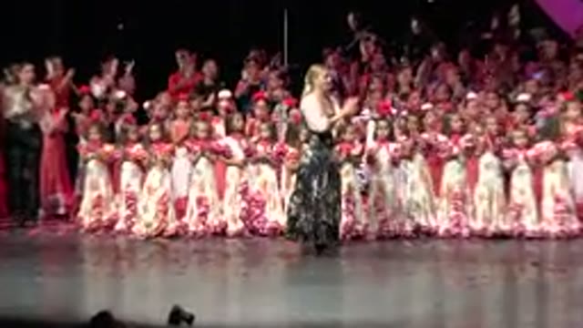 CABO SAN LUCAS MEXICO-2019: Woman Clapping in Front of a Large Crowd at Stage Performance