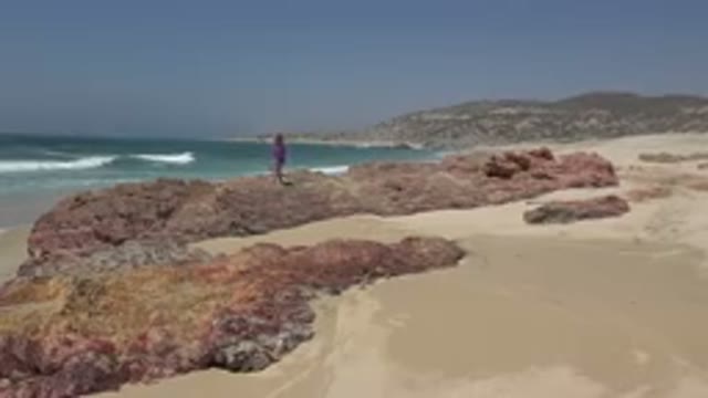 CABO SAN LUCAS MEXICO-2019: Little Girl Exploring Big Rocks By The Beach