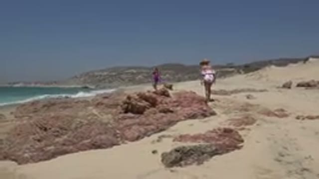 CABO SAN LUCAS MEXICO-2019: Mom And Daughter At The Beach Playing In The Sand