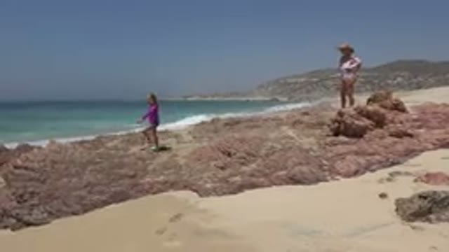 CABO SAN LUCAS MEXICO-2019: Mom Daughter And Dog Having Fun Playing In The Rocks