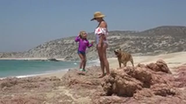 CABO SAN LUCAS MEXICO-2019: Mom And Daughter Playing In The Sand On The Beach