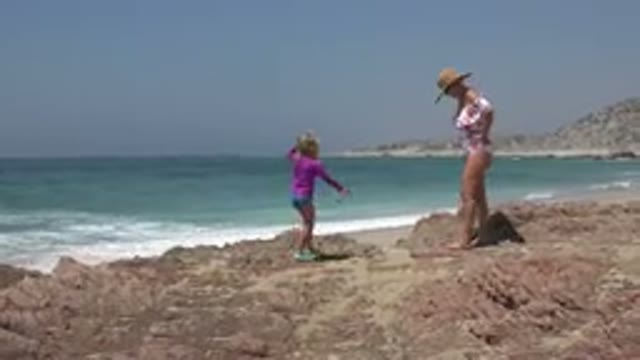 CABO SAN LUCAS MEXICO-2019: A Little Girl Playing With Her Mom On The Rocks