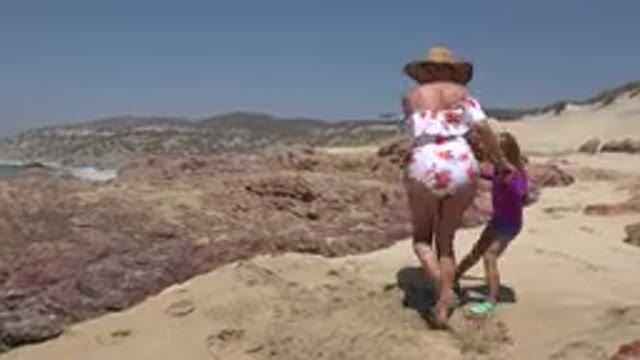 CABO SAN LUCAS MEXICO-2019: Mother and Daughter Having Fun on a Rocky Shore
