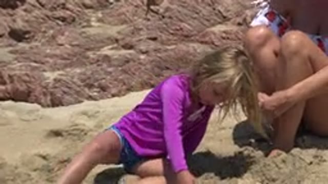 CABO SAN LUCAS MEXICO-2019: Girl Wearing Purple Shirt Walks To Woman Wearing Tan