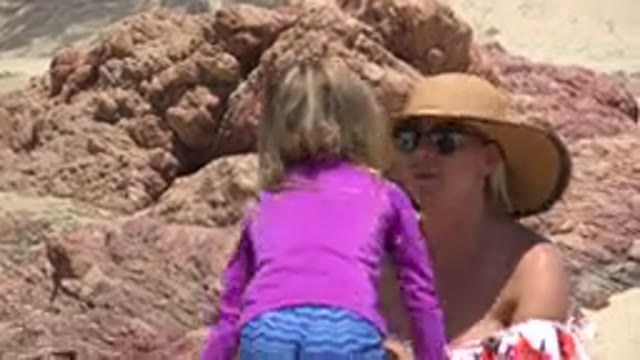 CABO SAN LUCAS MEXICO-2019: Mother Wearing Hat Is Playing With Her Daughter In