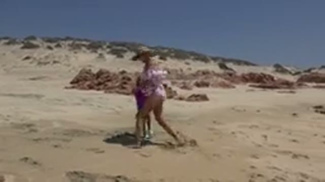 CABO SAN LUCAS MEXICO-2019: Girl Wearing Purple Shirt Dances on Beach