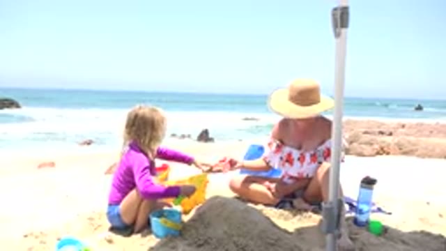 CABO SAN LUCAS MEXICO-2019: A Sunny Day At The Beach With A Child And A Woman