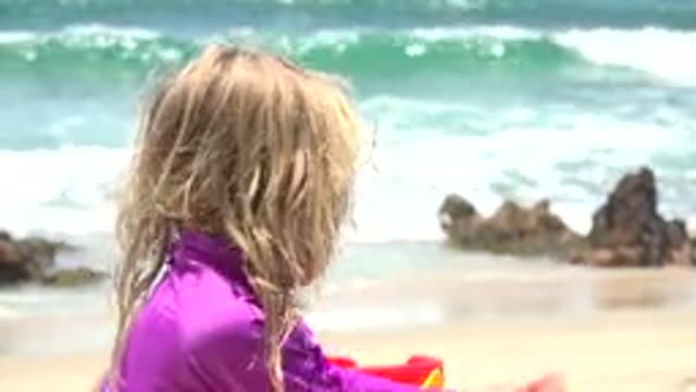 CABO SAN LUCAS MEXICO-2019: Girl Wearing Purple Shirt Plays With Off Screen Object