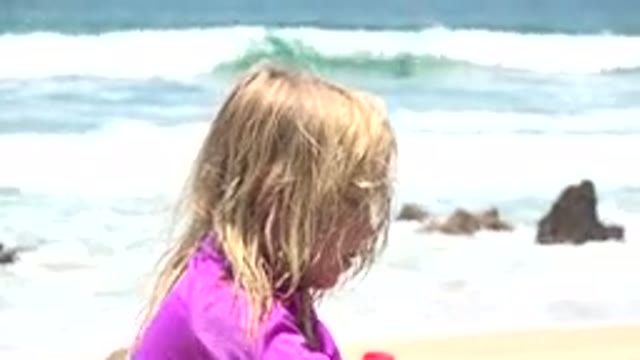 CABO SAN LUCAS MEXICO-2019: Blonde Child Playing On The Beach Sand With Sea