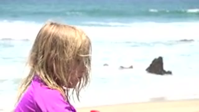 CABO SAN LUCAS MEXICO-2019: A Cute Child Is Sitting Along In The Beach On A