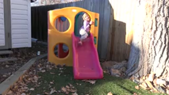 WESTMINSTER COLORADO-2019: A Little Girl Playing On A Slide Bridge At A Playground