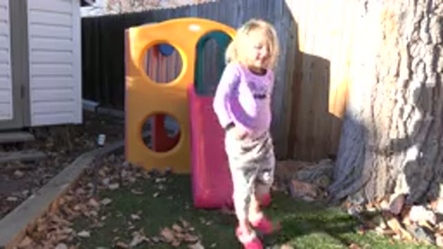 WESTMINSTER COLORADO-2019: Little Girl Playing In A Backyard On A Beautiful