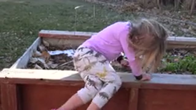 WESTMINSTER COLORADO-2019: Young Girl In Pajamas Plays In Flower Bed In The
