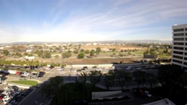 LOS ANGELES CALIFORNIA-2019: Moderate Traffic And White Building On A Sunny Day