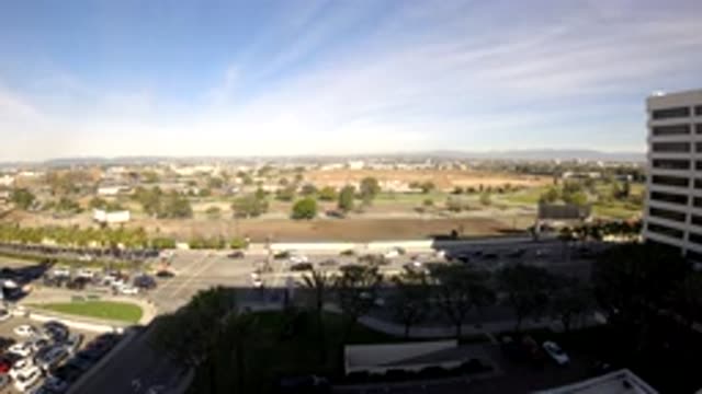 LOS ANGELES CALIFORNIA-2019: A Busy Intersection With A Town In The Background