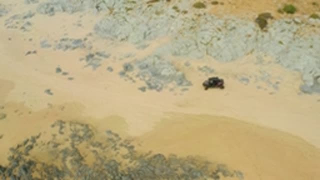 LAGUNA BEACH LOS CABOS BCS MEXICO-2021: 4x4 Vehicle Traversing Sandy Rocky Terrain