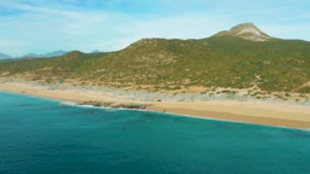 LAGUNA BEACH LOS CABOS BCS MEXICO-2021: Gentle Waves Lapping a Sandy Beach Coastline