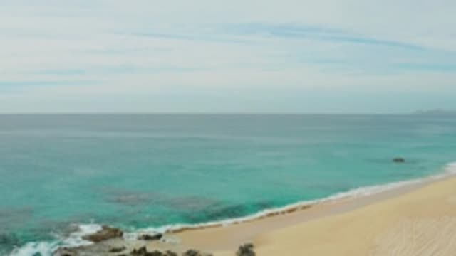 LAGUNA BEACH LOS CABOS BCS MEXICO-2021: Waves Crashing Against Rocky Shoreline at Beach