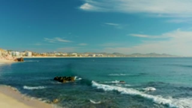 PLAYA ACAPULQUITO LOS CABOS BCS MEXICO-2021: Waves Breaking on Sandy Beach with Rocky Outcrops