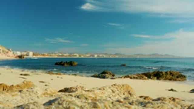 PLAYA ACAPULQUITO LOS CABOS BCS MEXICO-2021: Waves Breaking on Sandy Beach with Rocky Outcrops