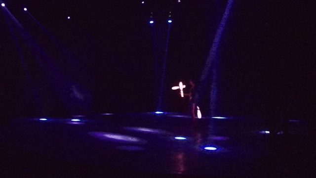SAN JOSE DEL CABO BCS MEXICO-2022: Glowing Staff Performer on Dark Stage with Color Shifts
