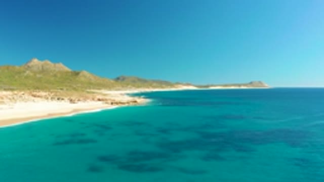 BUZZARDS EAST CAPE LOS CABOS BCS MEXICO-2022: Sandy Beach with Gentle Ocean Waves From Above