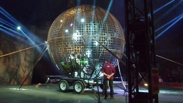 SAN JOSE DEL CABO BCS MEXICO-2022: Giant Golden Sphere on Stage with Person Adjusting