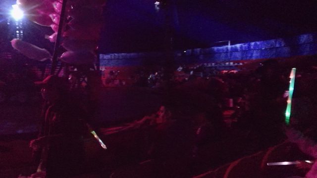 SAN JOSE DEL CABO BCS MEXICO-2022: Concert Audience Dancing with Glow Sticks Under Colorful Lights