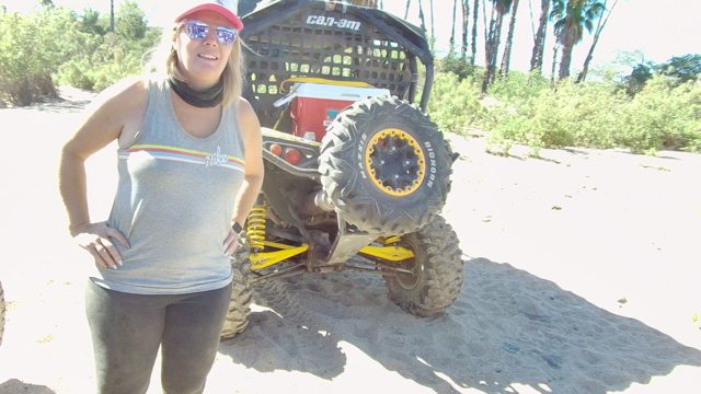 LOS CABOS BCS MEXICO-2022: Woman Posing with Off-road Vehicle on Sandy Beach