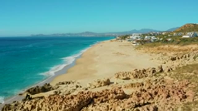 BUZZARDS EAST CAPE LOS CABOS BCS MEXICO-2022: Sandy Beach and Turquoise Ocean Aerial Pan