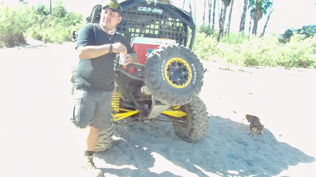 LOS CABOS BCS MEXICO-2022: Man Standing by ATV As Small Dog Moves Past