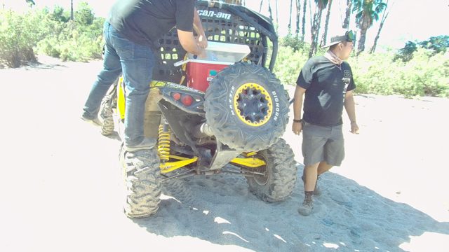 LOS CABOS BCS MEXICO-2022: Two Men Interacting with an ATV on Sandy Ground