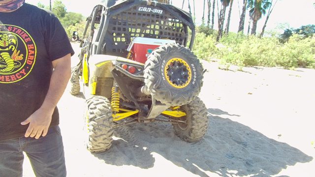 LOS CABOS BCS MEXICO-2022: Man Making Hand Gestures Beside Utility Vehicle on Sand