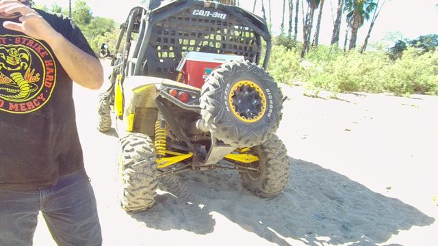 LOS CABOS BCS MEXICO-2022: Man Gesturing by Can-Am UTV on Sandy Terrain