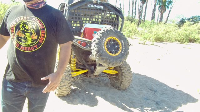 LOS CABOS BCS MEXICO-2022: Man Gesturing Near Off-Road Vehicle with Another Person Approaching