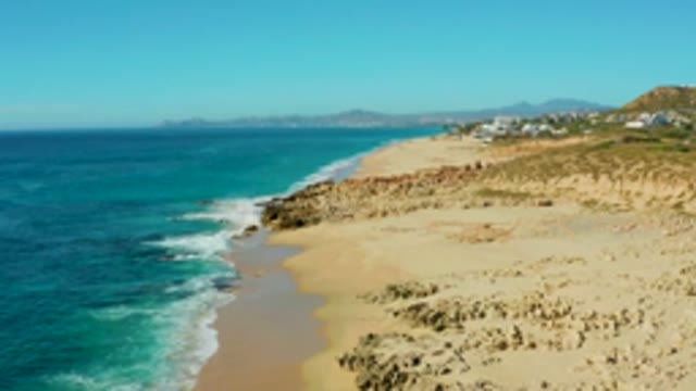 BUZZARDS EAST CAPE LOS CABOS BCS MEXICO-2022: Coastal Waves Crashing on Sandy Shoreline