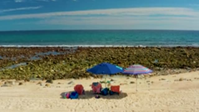 EL TULE LOS CABOS BCS MEXICO-2022: Beach Umbrellas and Chairs Under Clearing Sky