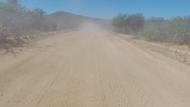 LOS CABOS BCS MEXICO-2022: Dusty Unpaved Road with Receding Vehicle