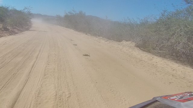 LOS CABOS BCS MEXICO-2022: Dusty Dirt Road in Arid Terrain From Vehicle
