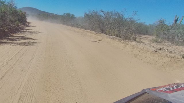LOS CABOS BCS MEXICO-2022: Vehicle Driving on Dusty Desert Road