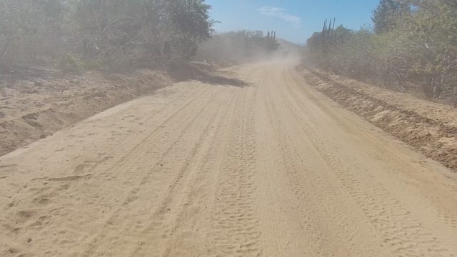 LOS CABOS BCS MEXICO-2022: Vehicle Creating Dust on Arid Dirt Road