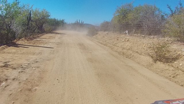 LOS CABOS BCS MEXICO-2022: Dust Cloud From Vehicle on Arid Dirt Road
