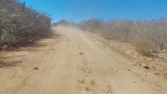 LOS CABOS BCS MEXICO-2022: Vehicle Driving on Dusty Arid Dirt Road